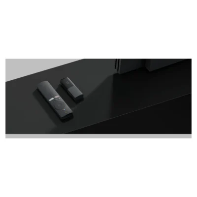 Mi TV Stick (1080p, EU) — complete original stick and remote in a room setting