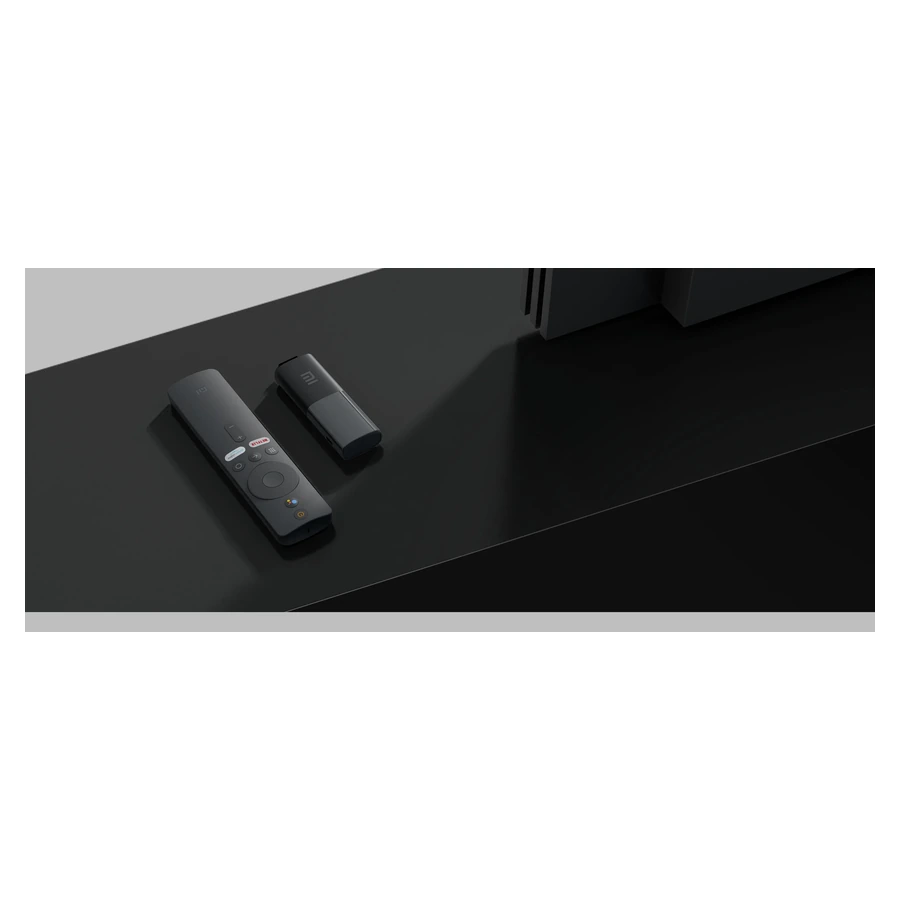 Mi TV Stick (1080p, EU) — complete original stick and remote in a room setting