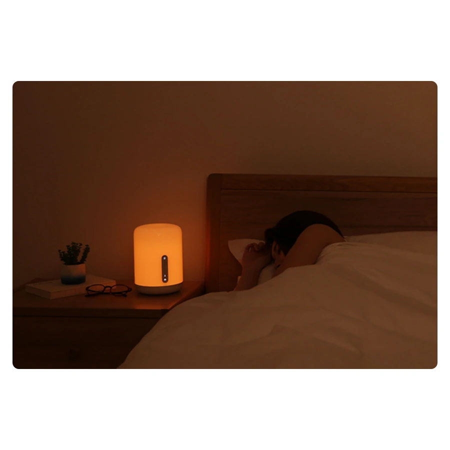 Mi Bedside Lamp 2 — complete lamp glowing warm beside a bed