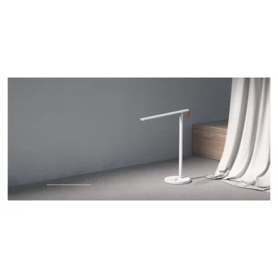 Mi LED Desk Lamp 1S — whole lamp on a desk beside a curtain