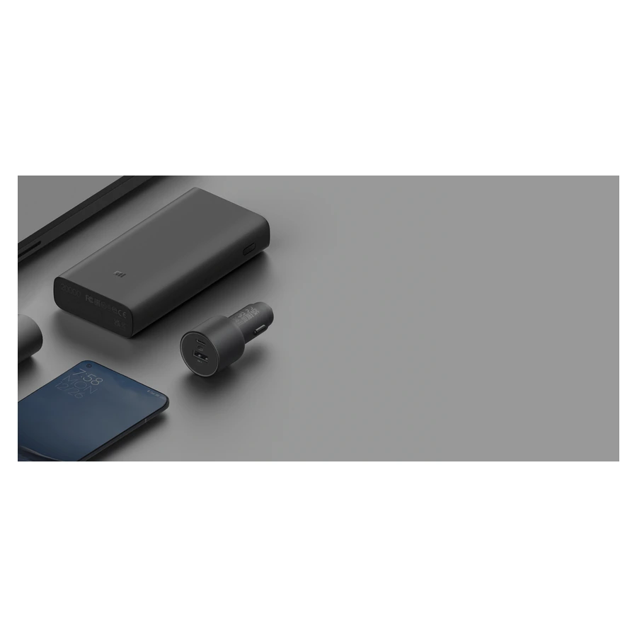 Complete Xiaomi 67W Car Charger beside compatible mobile devices on a desk