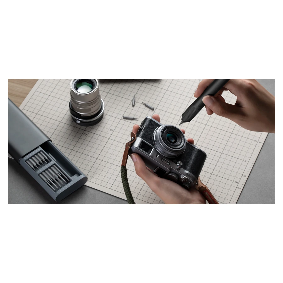 Xiaomi Electric Precision Screwdriver — complete tool held beside a camera