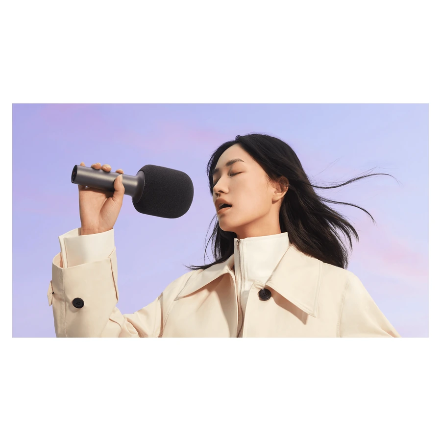 Complete handheld Xiaomi Karaoke Microphone in use by a singer