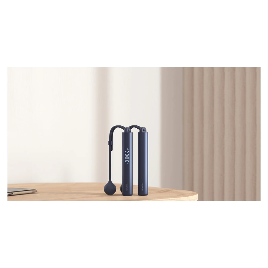 Xiaomi Smart Jump Rope — complete handles and swinging balls on a table