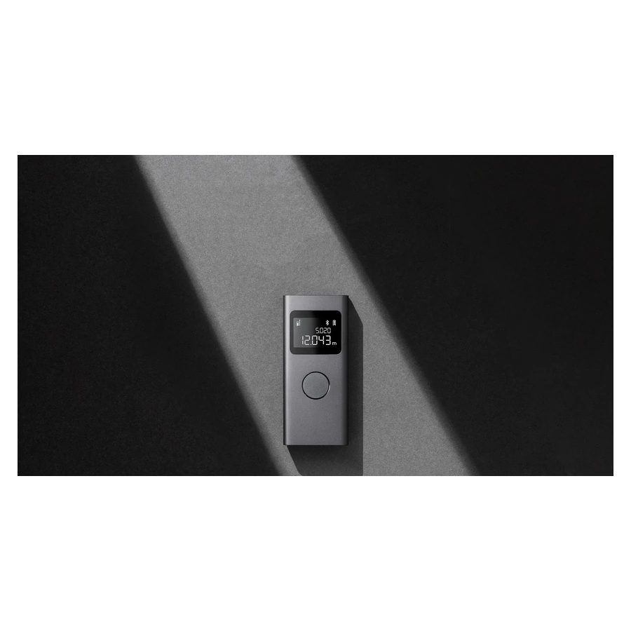 Xiaomi Smart Laser Measure — complete device against a wall